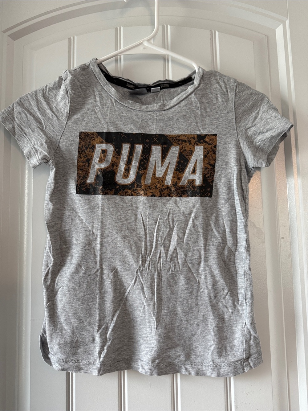Gently worn Puma Kids' Light Gray Logo Graphic Tee with Bronze Accent